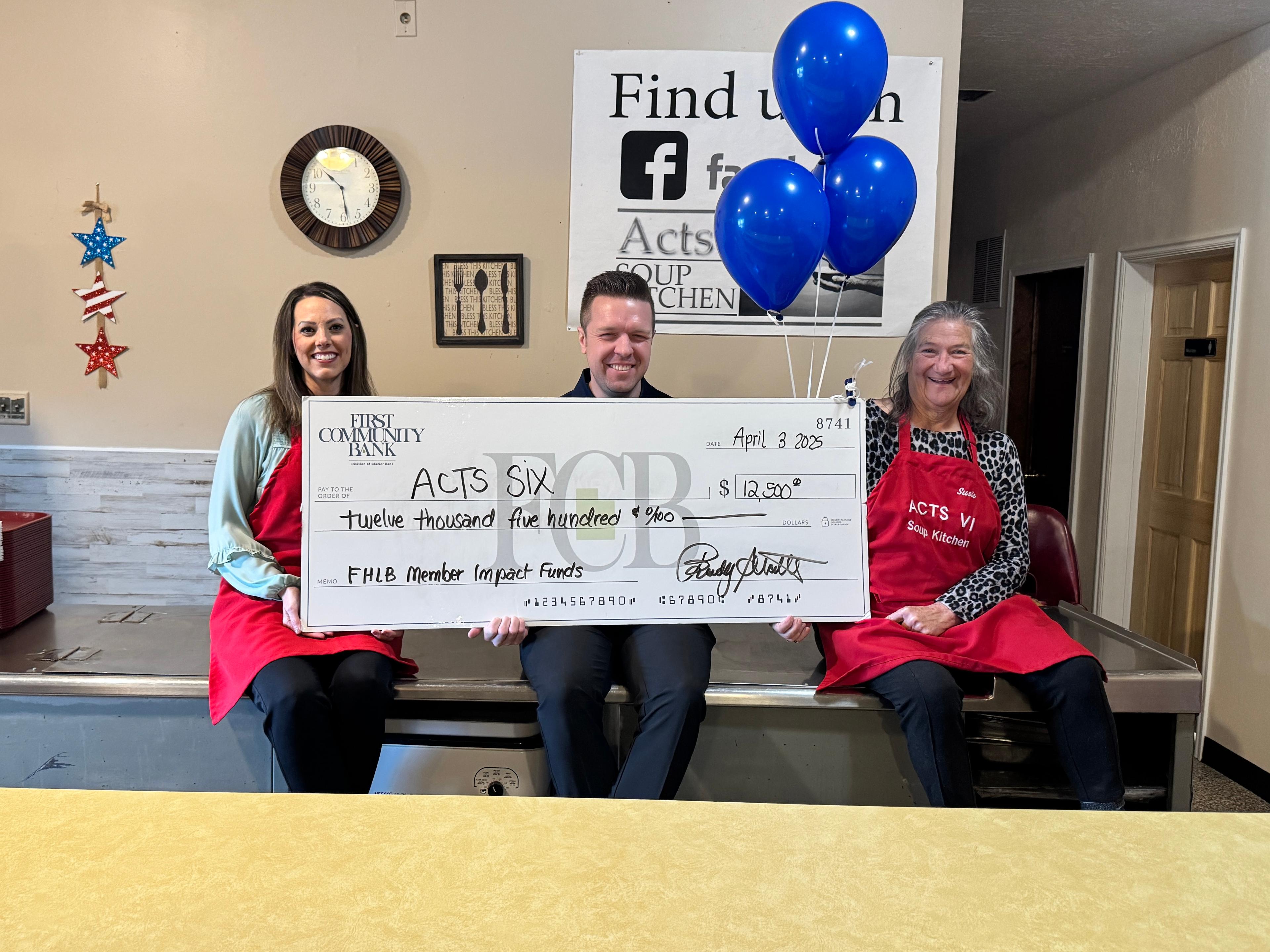 soup kitchen board members with First Community Bank check