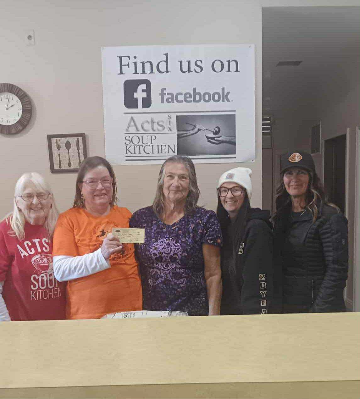 soup kitchen board members with STS Trucking check